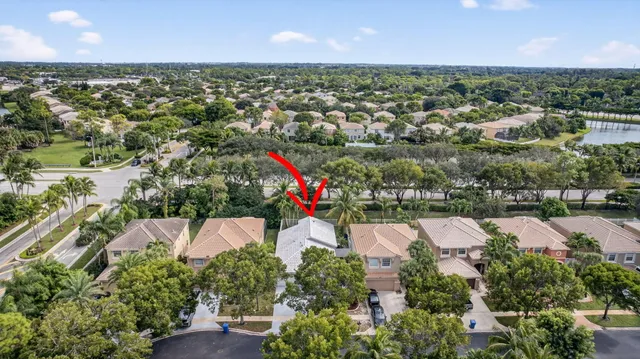 an aerial view of residential houses with outdoor space and trees
