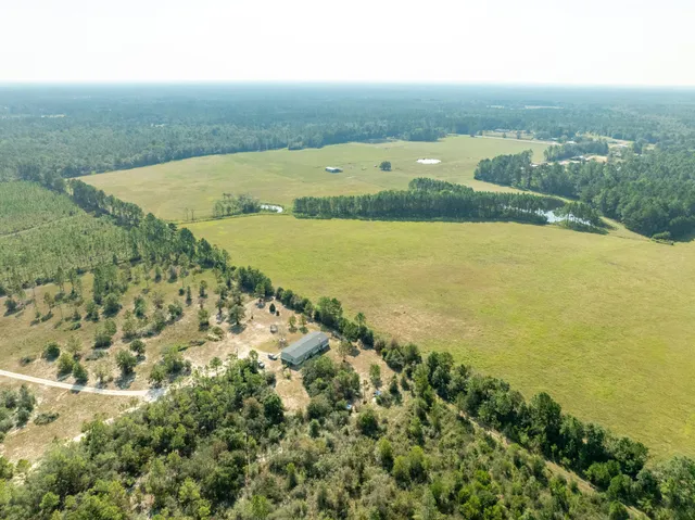 an aerial view of a house with a yard