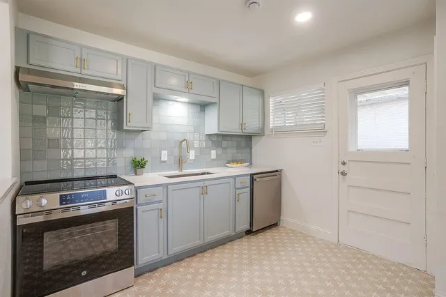 a kitchen with a stove and a sink