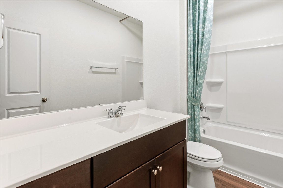 14105 Nightview Cove Pflugerville, TX 78660 - Photo 21 of 36 a bathroom with a sink a toilet a tub and shower