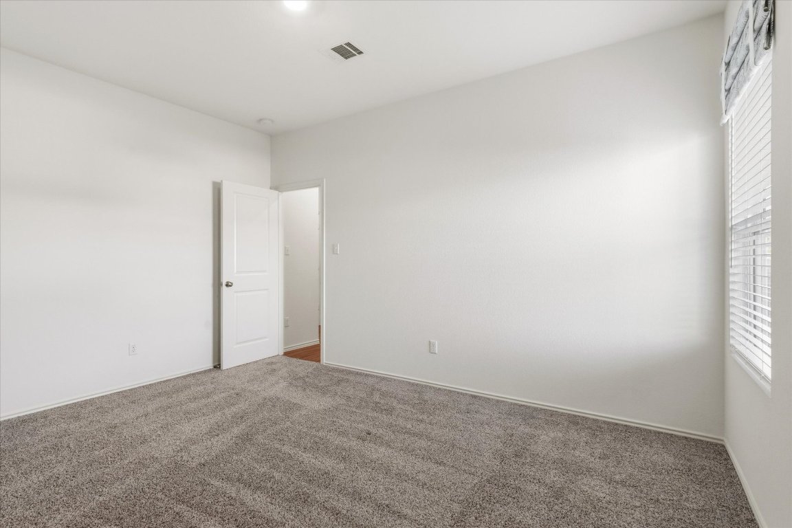 14105 Nightview Cove Pflugerville, TX 78660 - Photo 33 of 36 an empty room with windows and closet