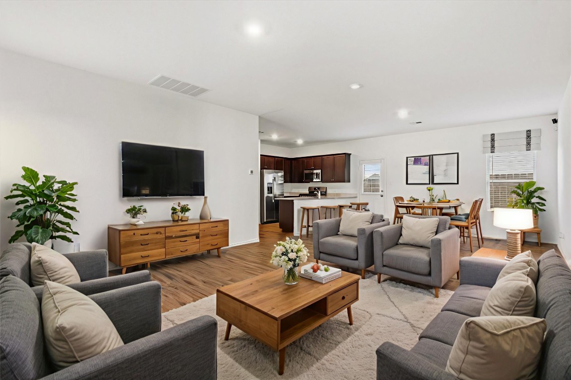14105 Nightview Cove Pflugerville, TX 78660 - Photo 9 of 36 a living room with furniture kitchen view and a flat screen tv