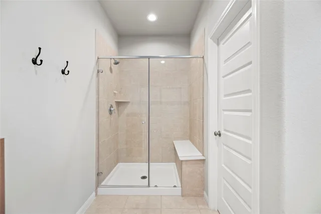a bathroom with a glass shower door