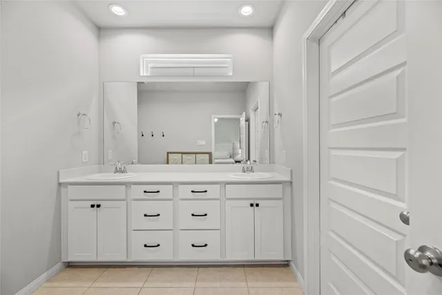 a bathroom with a sink vanity and mirror