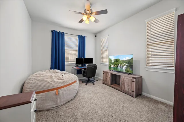 a living room with furniture a chandelier and a window