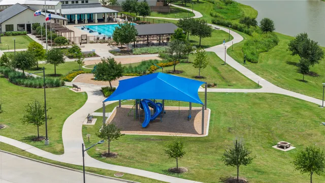 an aerial view of a house with swimming pool garden and patio