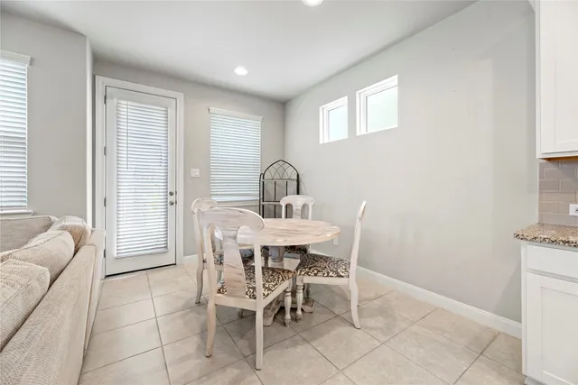 a view of a dining room with furniture and window