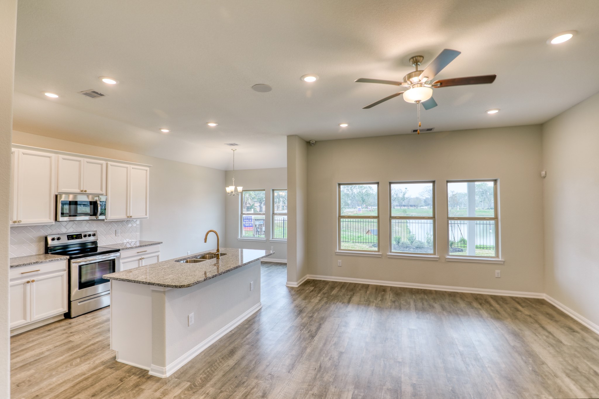 201 Bryan Way Angleton, TX 77515 - Photo 15 of 38 a large kitchen with stainless steel appliances a large counter top a stove a sink and a refrigerator