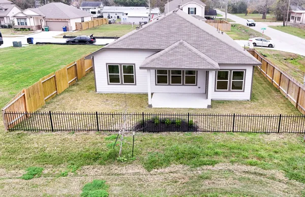 a front view of a house with a yard and fence