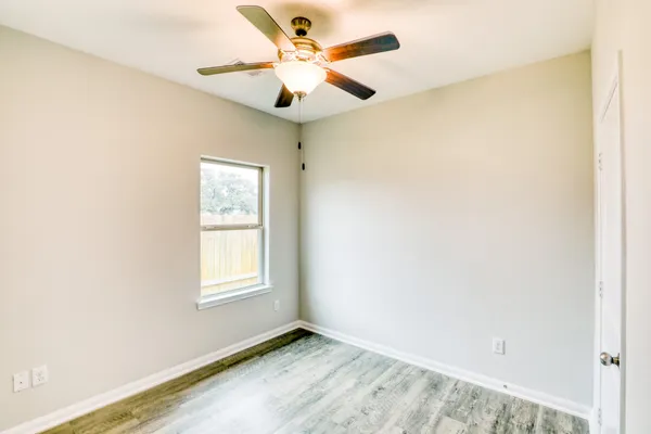 a view of hallway with wooden floor