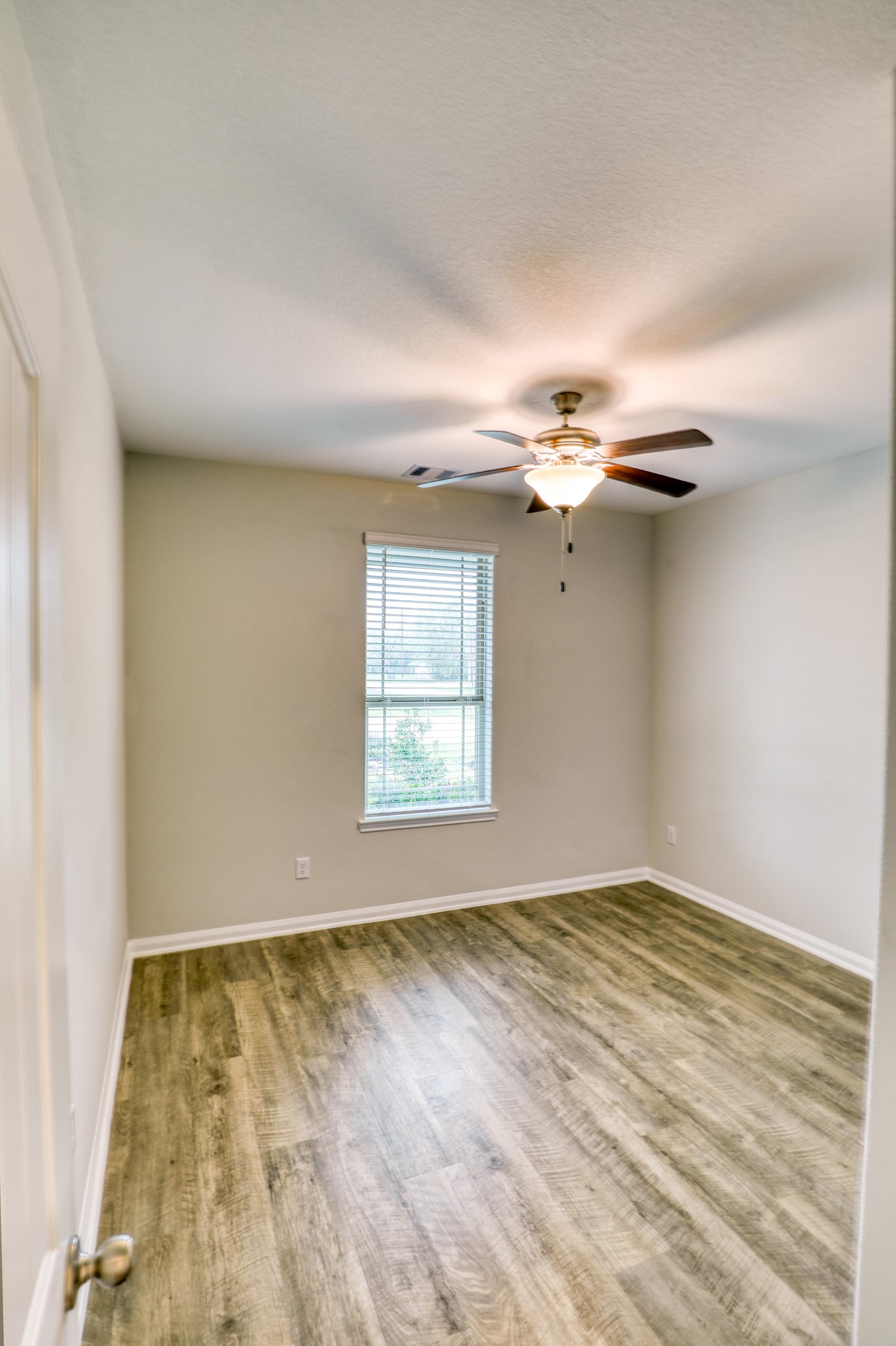 201 Bryan Way Angleton, TX 77515 - Photo 35 of 38 wooden floor in an empty room with a window