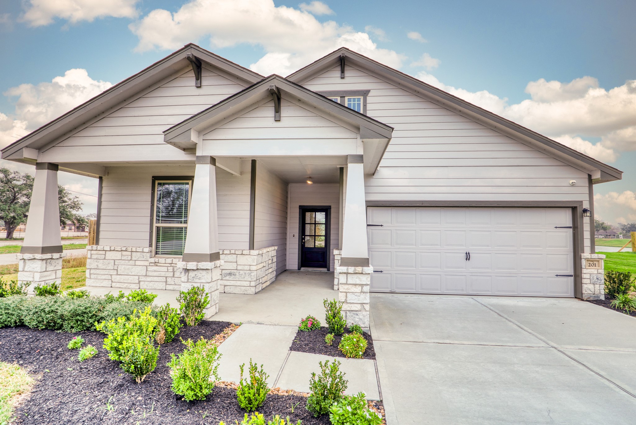201 Bryan Way Angleton, TX 77515 - Photo 37 of 38 a front view of a house with a yard and potted plants