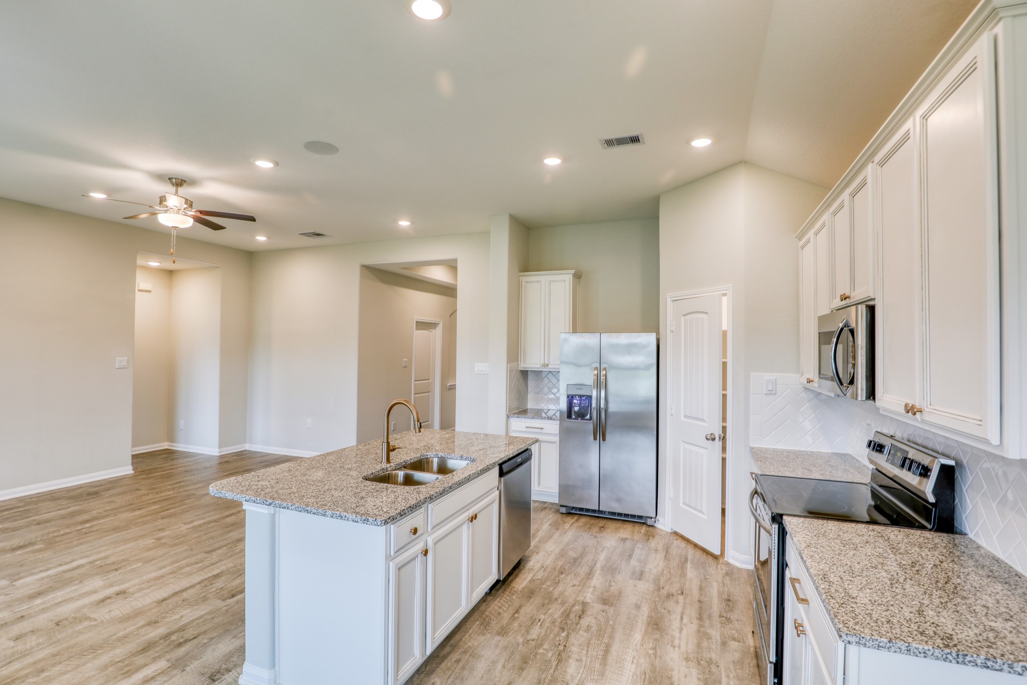 201 Bryan Way Angleton, TX 77515 - Photo 7 of 38 a kitchen with stainless steel appliances granite countertop a sink stove and refrigerator