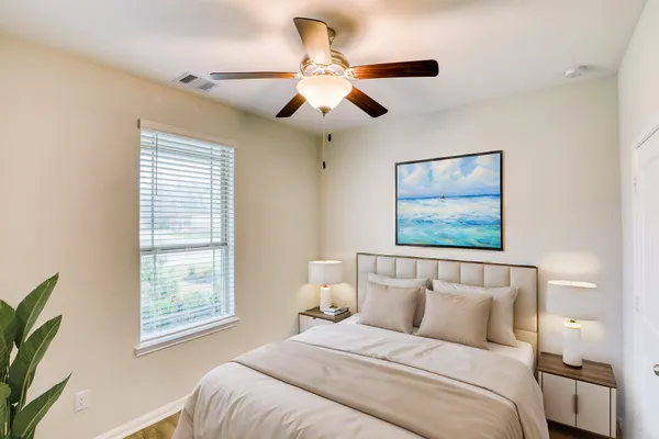 a bedroom with bed and window