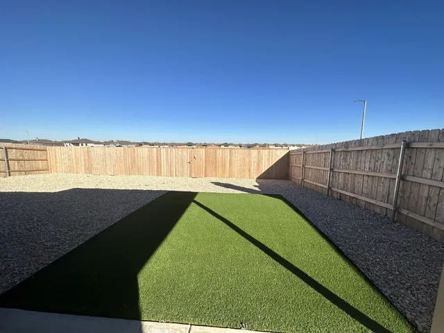 a view of a swimming pool with a yard