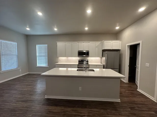 a large kitchen with stainless steel appliances
