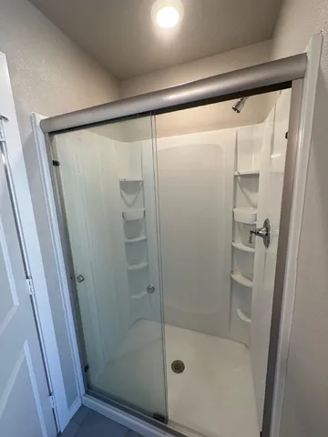 a bathroom with a glass shower door