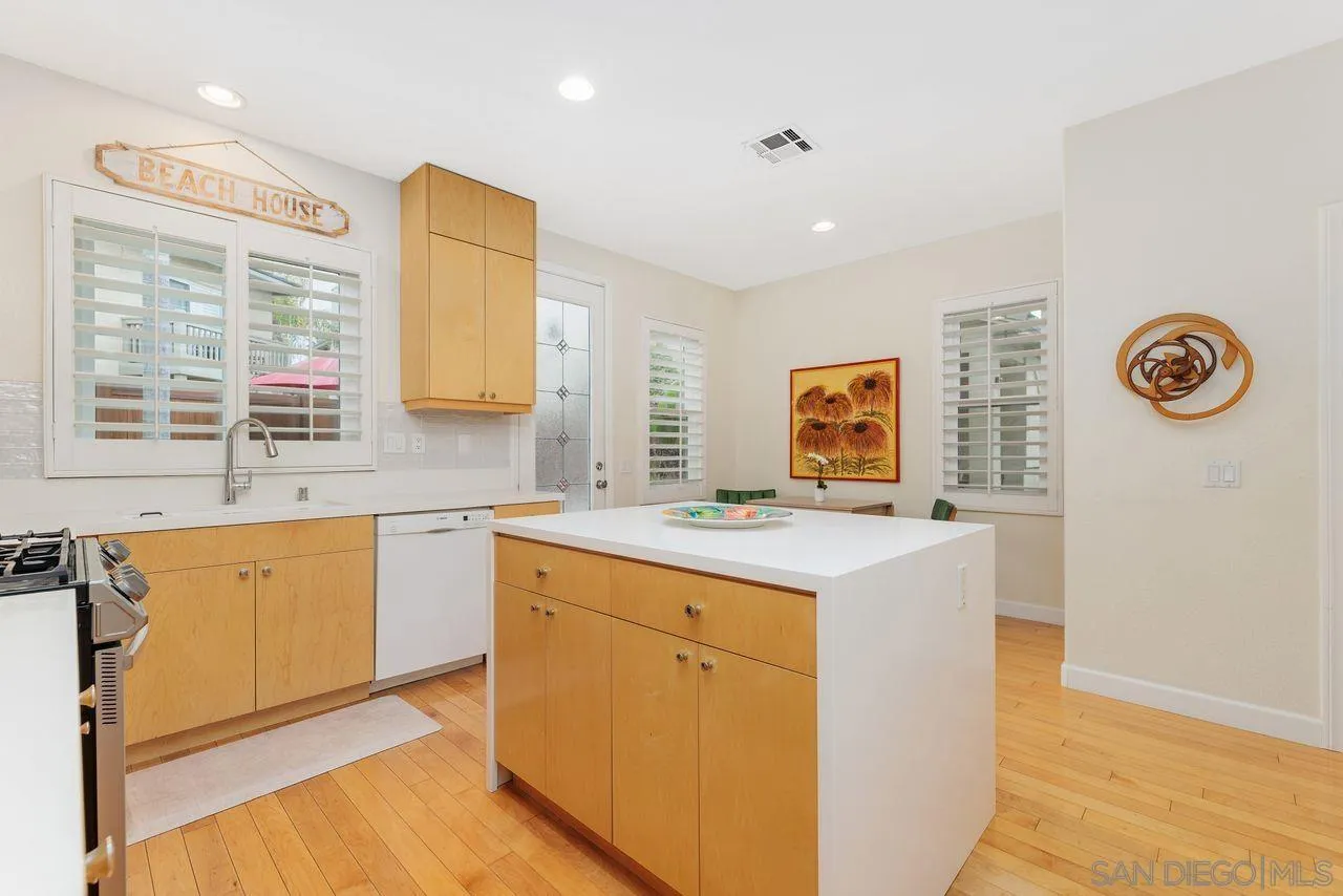 7390 Seafarer Place Carlsbad, CA 92011 - Photo 12 of 41 a view of cabinets a sink and a stove top oven