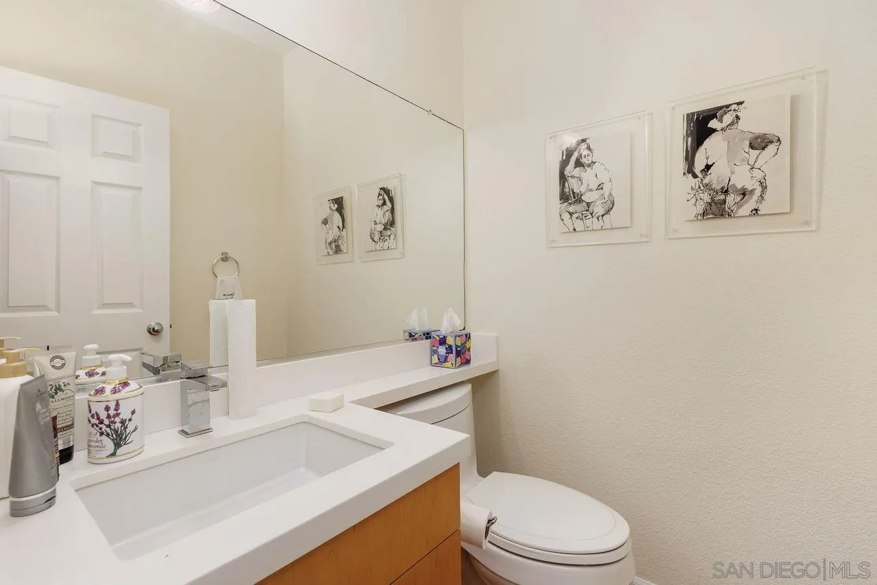 7390 Seafarer Place Carlsbad, CA 92011 - Photo 14 of 41 a bathroom with a sink mirror vanity and toilet