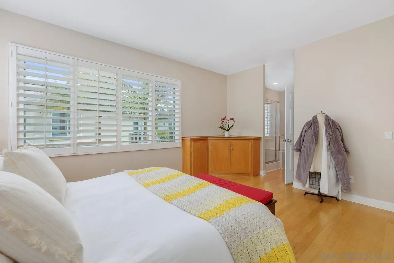 7390 Seafarer Place Carlsbad, CA 92011 - Photo 20 of 41 a bedroom with a bed next to a large window