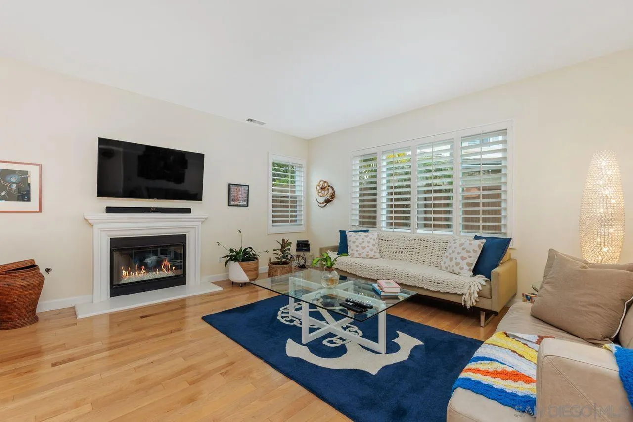 7390 Seafarer Place Carlsbad, CA 92011 - Photo 4 of 41 a living room with furniture fireplace and flat screen tv