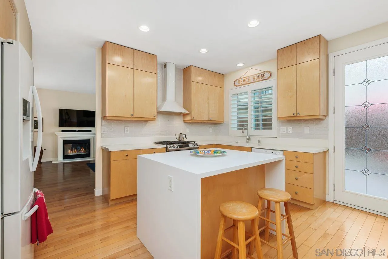 7390 Seafarer Place Carlsbad, CA 92011 - Photo 8 of 41 a kitchen with stainless steel appliances granite countertop a sink stove and refrigerator
