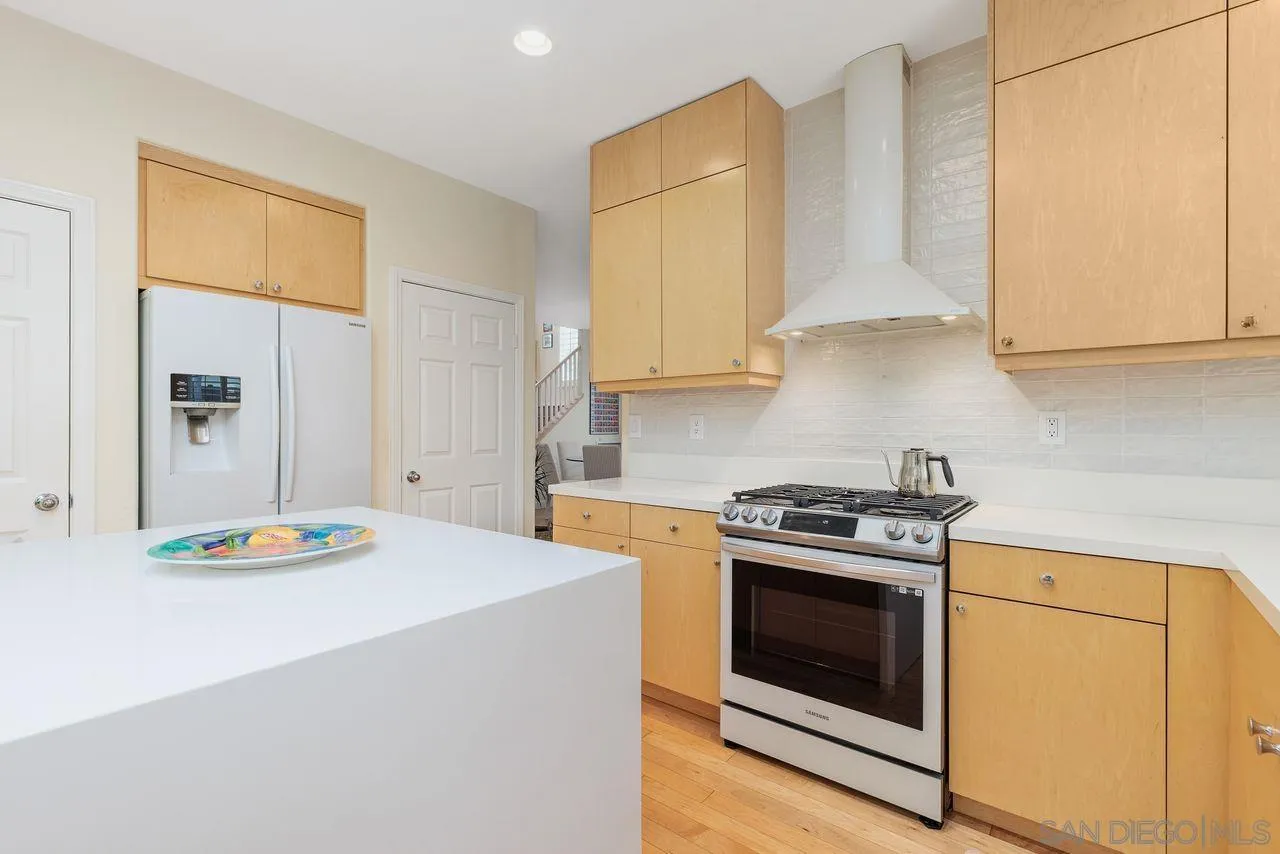 7390 Seafarer Place Carlsbad, CA 92011 - Photo 10 of 41 a kitchen with stainless steel appliances granite countertop a stove a sink and a microwave