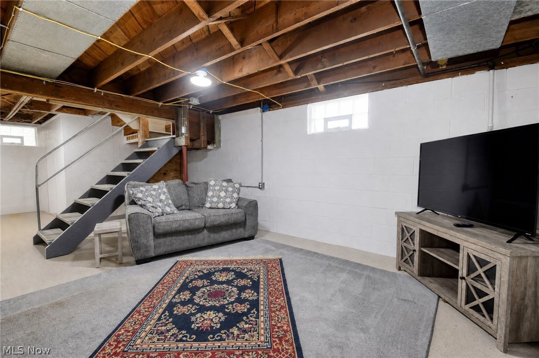 3864 State Road South Ashtabula, OH 44004 - Photo 28 of 50 Exposed wood ceiling beams, white painted block walls, and a metal staircase with handrails