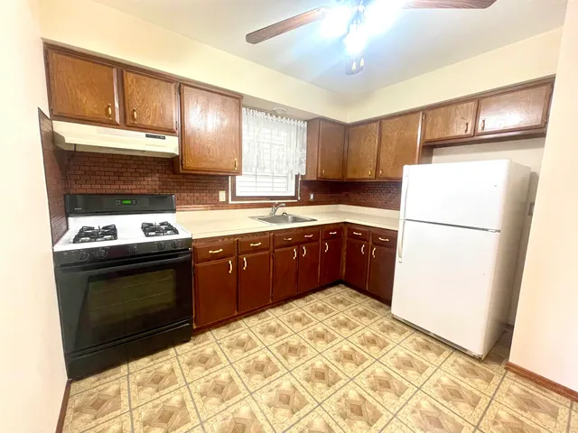 a bathroom with a sink shower and a mirror