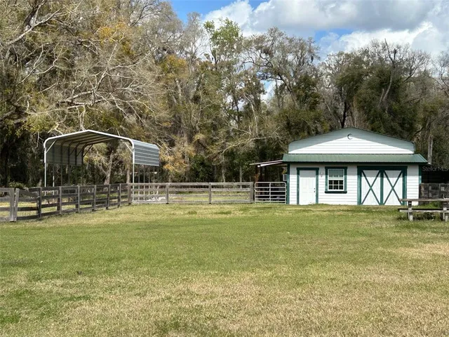a front view of a house with swimming pool having outdoor seating