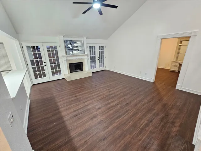 a view of a livingroom with furniture a fireplace wooden floor and window