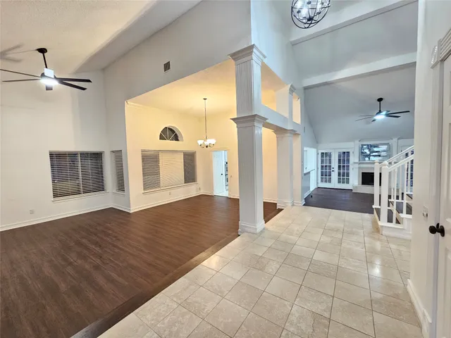 a view of a hallway with wooden floor and a fireplace