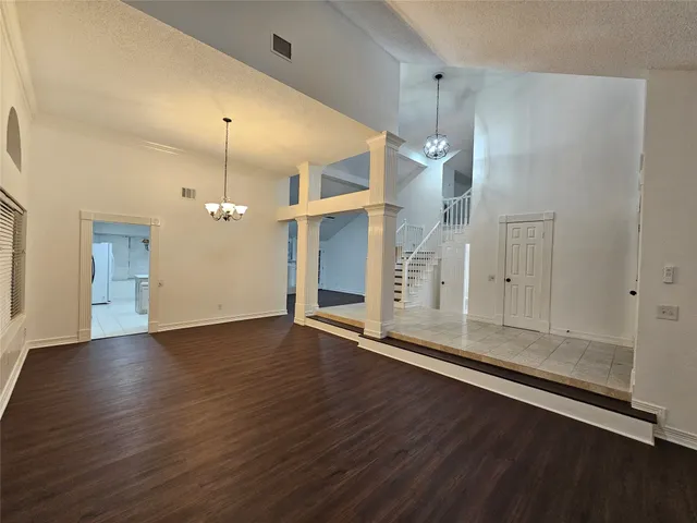an empty room with wooden floor and door
