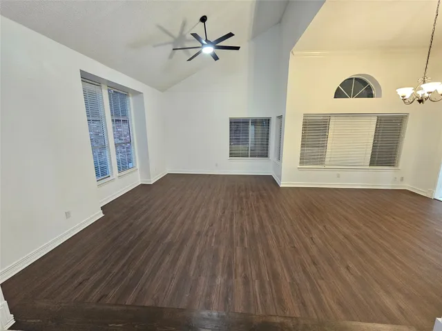 a view of a livingroom with wooden floor and a ceiling fan