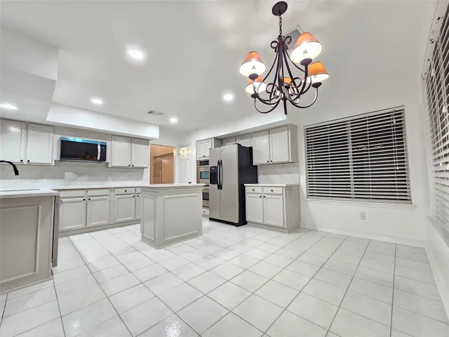 a kitchen with a refrigerator a sink dishwasher and a stove top oven