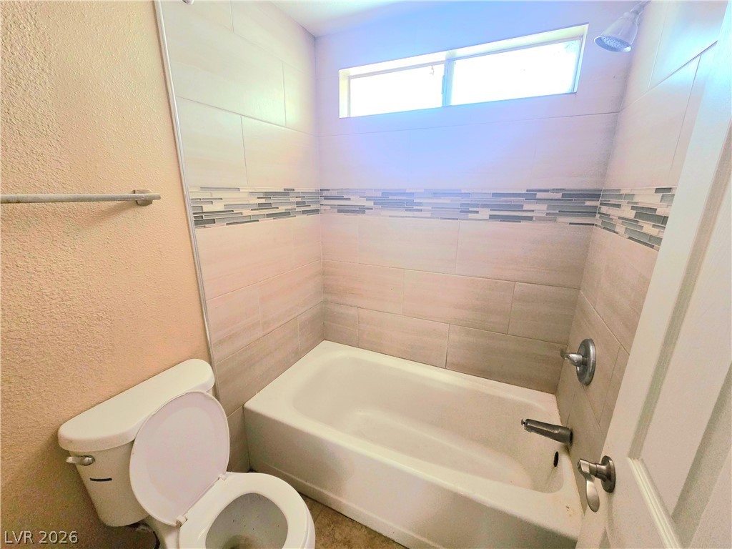 3648 Bronco Road Las Vegas, NV 89103 - Photo 21 of 24 A well-appointed bathroom featuring a clean bathtub and tasteful tile surround.