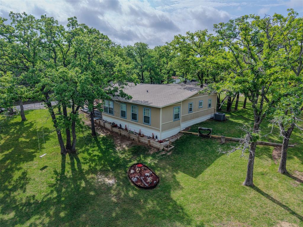 309 Tejas Trail Springtown, TX 76082 - Photo 28 of 40 a aerial view of a house with a yard table and chairs