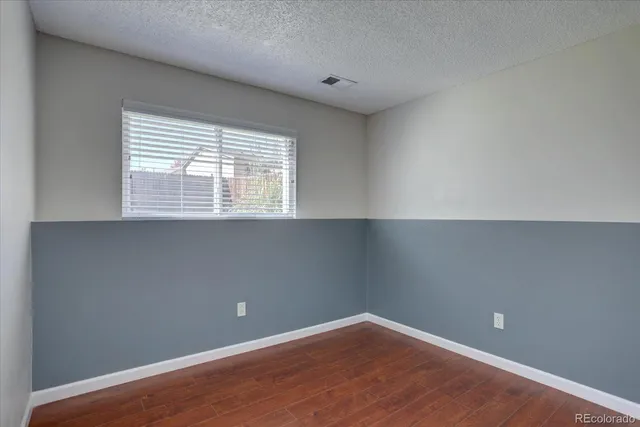 an empty room with wooden floor