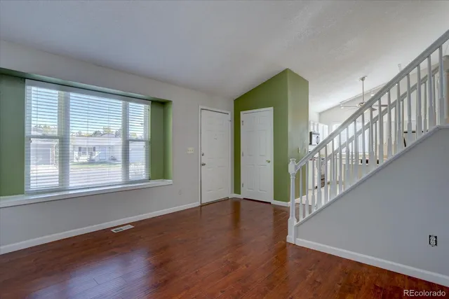 a view of entryway and hall with wooden floor