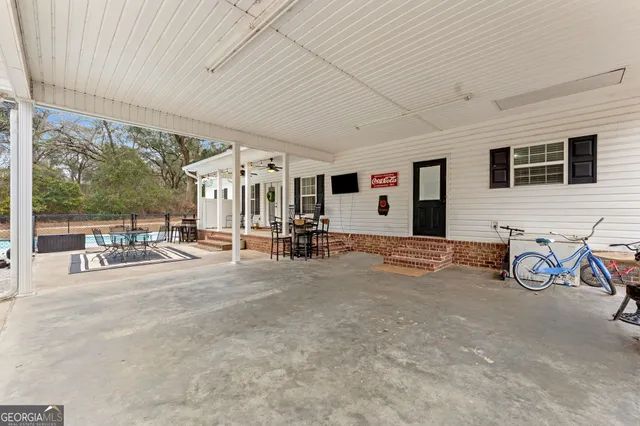 a backyard of a house with lots of green space and chandelier