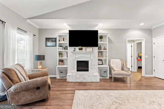 a living room with lots of furniture and chandelier