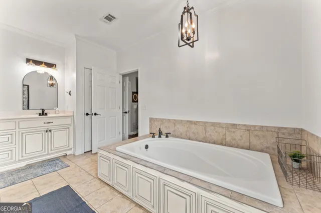 a bathroom with a tub a sink and a shower