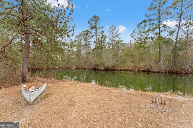 a view of a house with a yard and sitting area