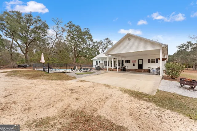 a view of white house with a yard