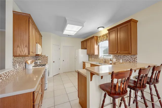 a view of a kitchen area with furniture and wooden floor