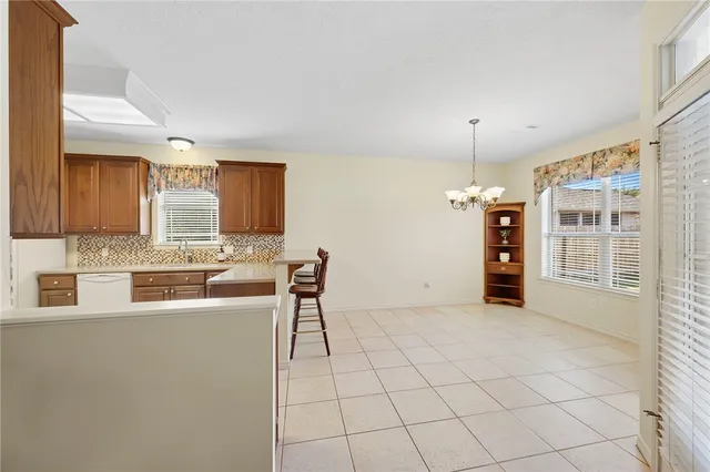 a kitchen with granite countertop a sink cabinets and window