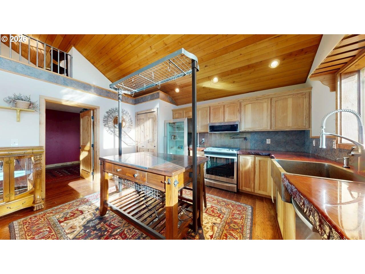 99106 East Freeman Lane Brookings, OR 97415 - Photo 11 of 37 a kitchen with stainless steel appliances kitchen island granite countertop a sink and cabinets