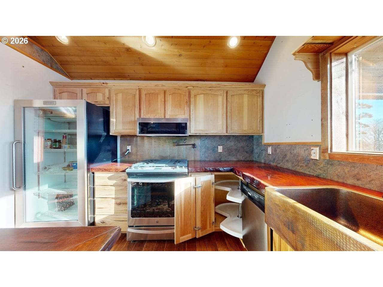 99106 East Freeman Lane Brookings, OR 97415 - Photo 14 of 37 a kitchen with stainless steel appliances kitchen island granite countertop a sink and cabinets