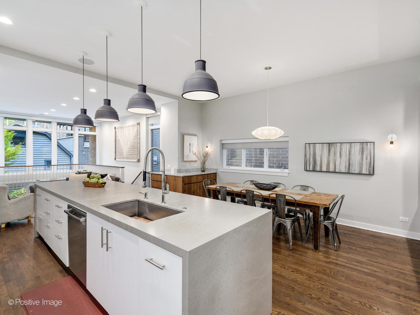 1821 West Cortland Street Chicago, IL 60622 - Photo 16 of 50 a kitchen with a stove a kitchen island a dining table and chairs with wooden floor