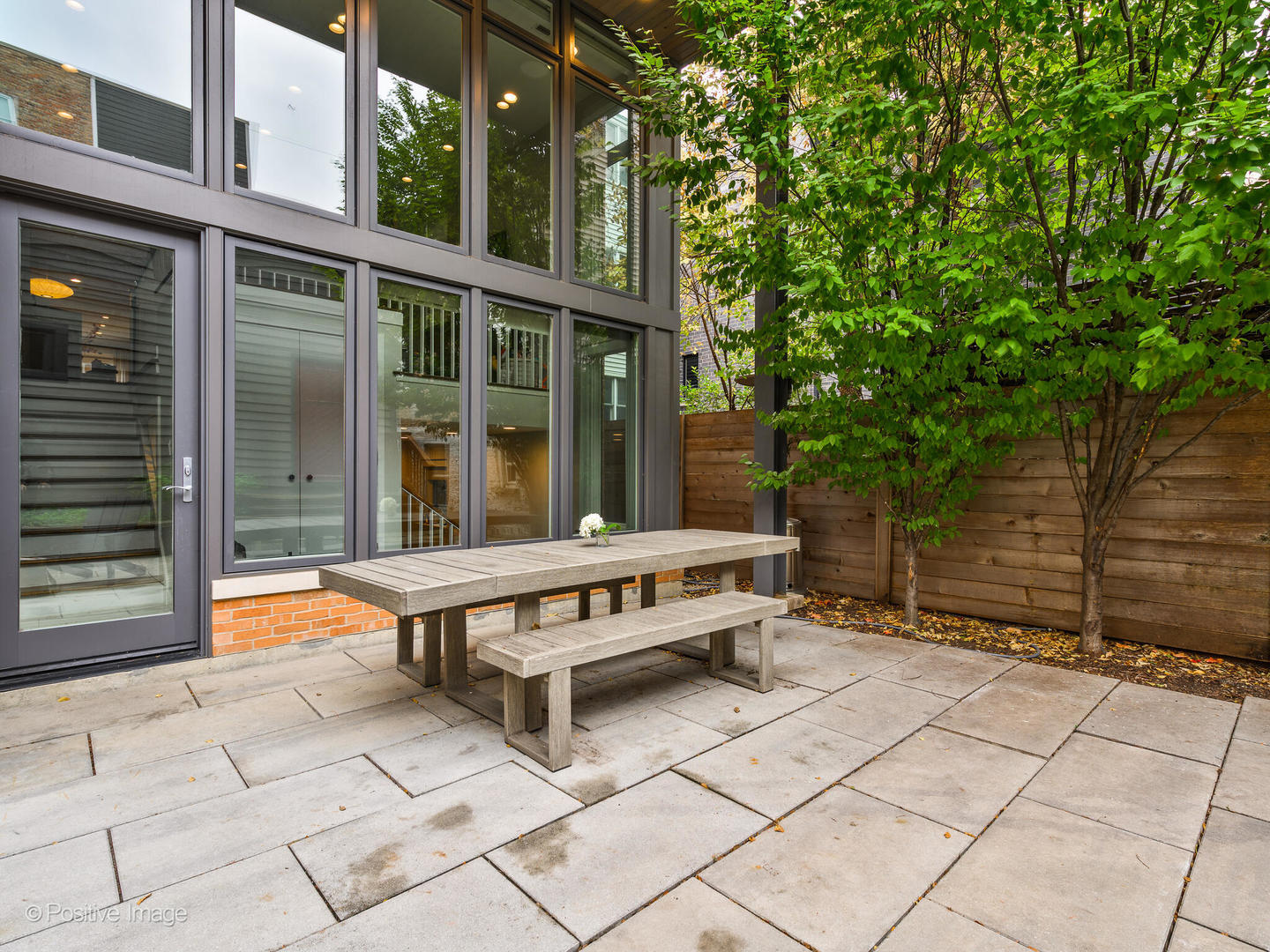 1821 West Cortland Street Chicago, IL 60622 - Photo 42 of 50 a backyard of a house with barbeque oven and wooden fence